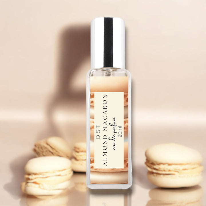 20ml bottle of Almond Macaron Eau de Parfum against a tan background with almond french macarons.