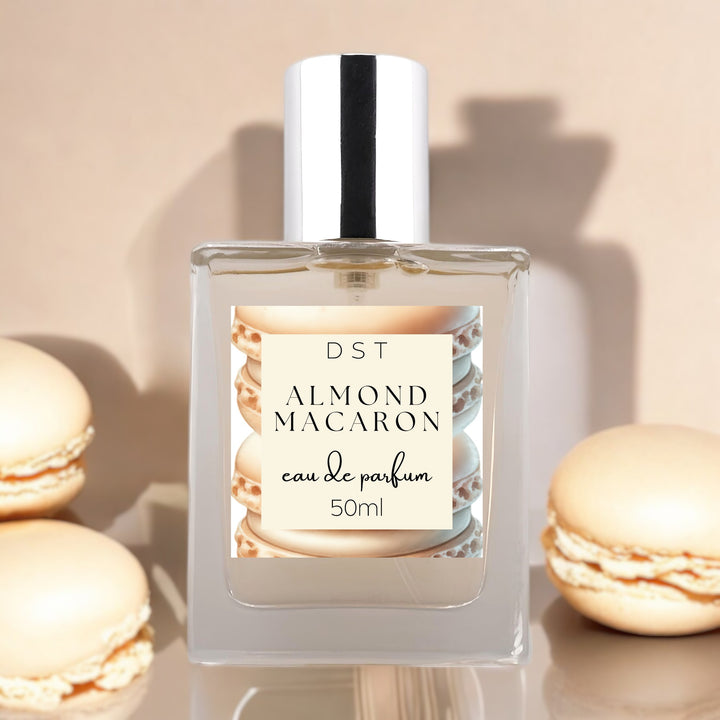 50ml bottle of Almond Macaron Eau de Parfum against a tan background with almond french macarons.