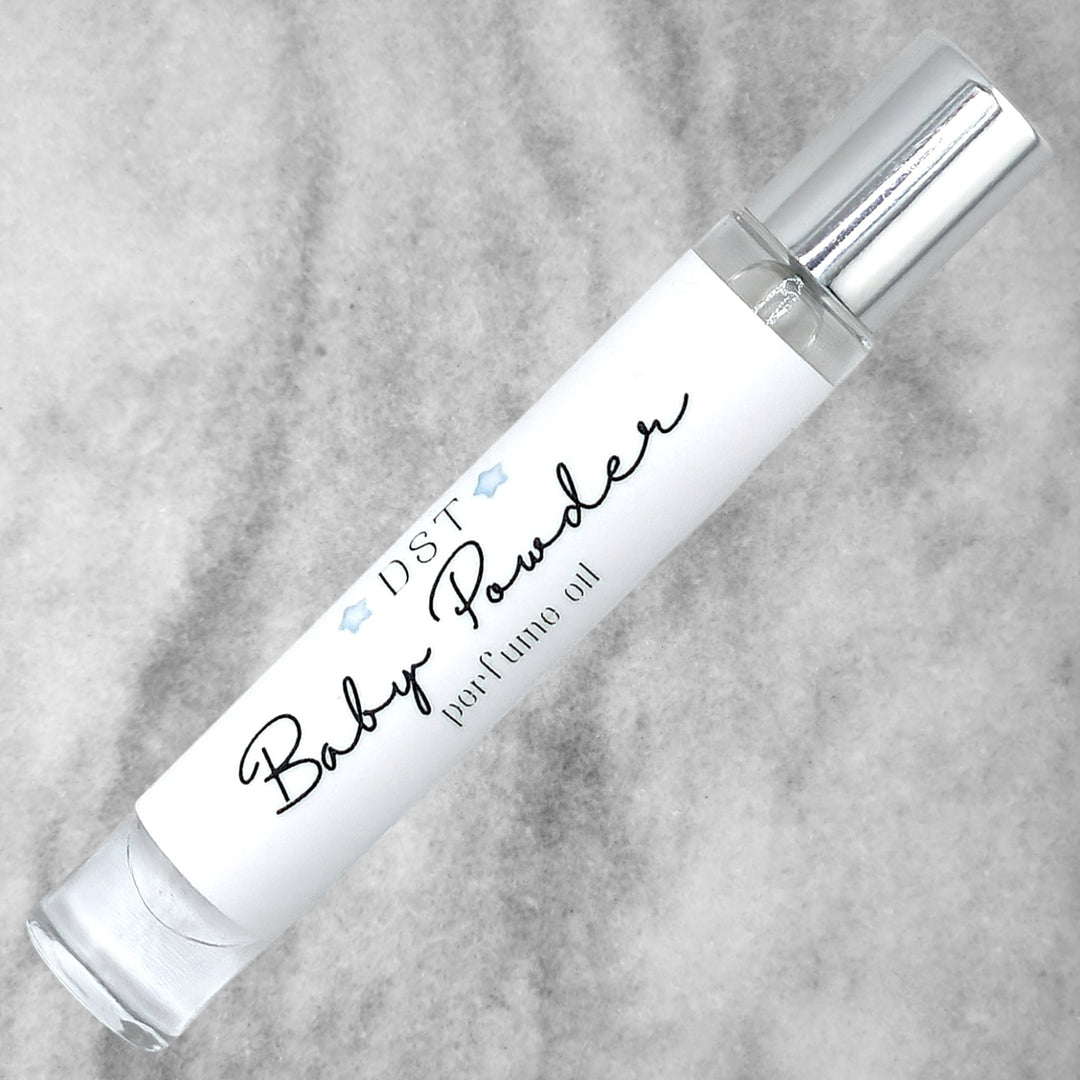 10ml bottle of Baby Powder perfume oil against a grey background. 