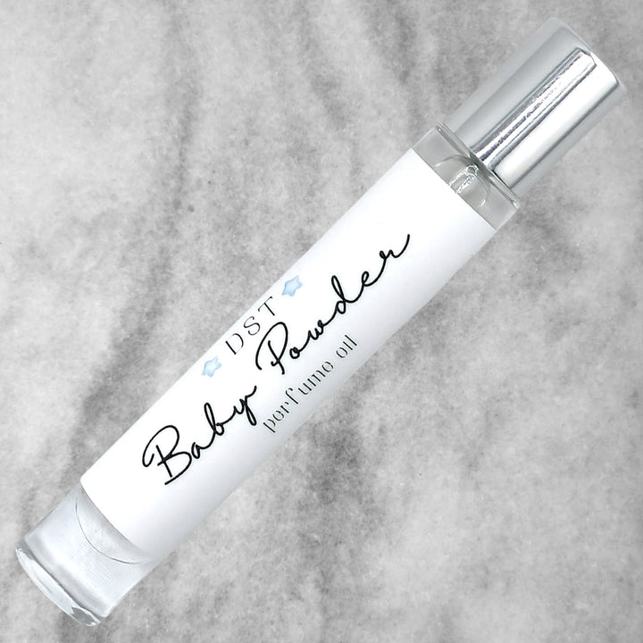 10ml bottle of Baby Powder perfume oil against a grey background. 