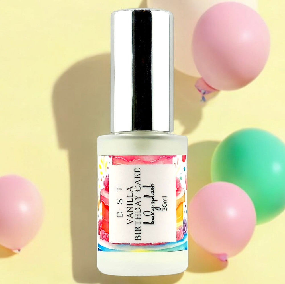 30ml bottle of Vanilla Birthday Cake body splash with pink and green balloons against a pastel yellow shadowy background.