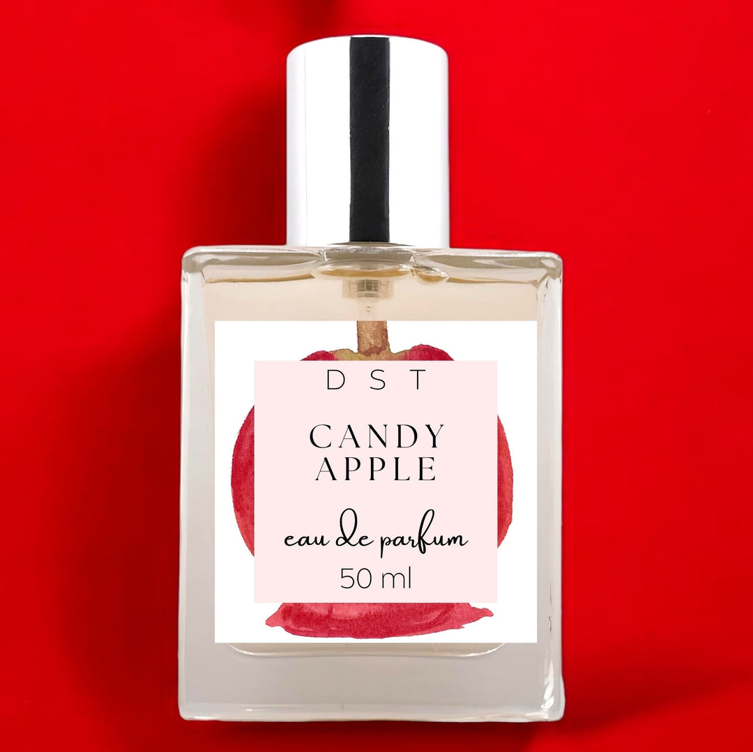 50ml bottle of Candy Apple Eau de Parfum on bright red background.