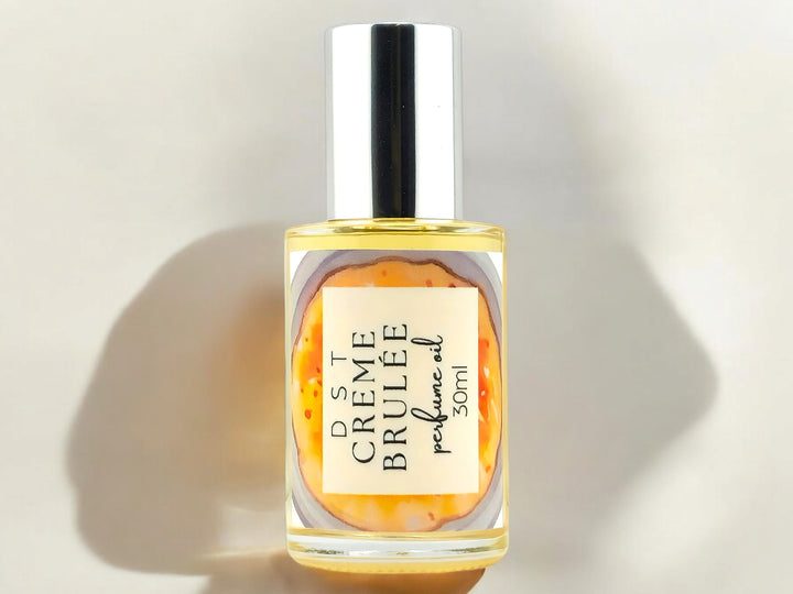 30ml bottle of Creme Brulee Perfume oil against a shadowy ivory background.