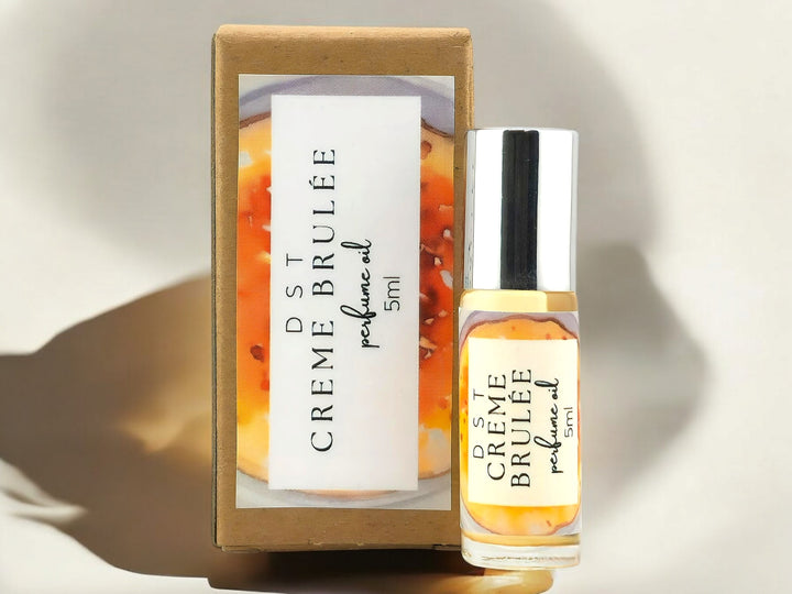 5ml bottle of Creme Brulee Perfume oil against a shadowy ivory background.