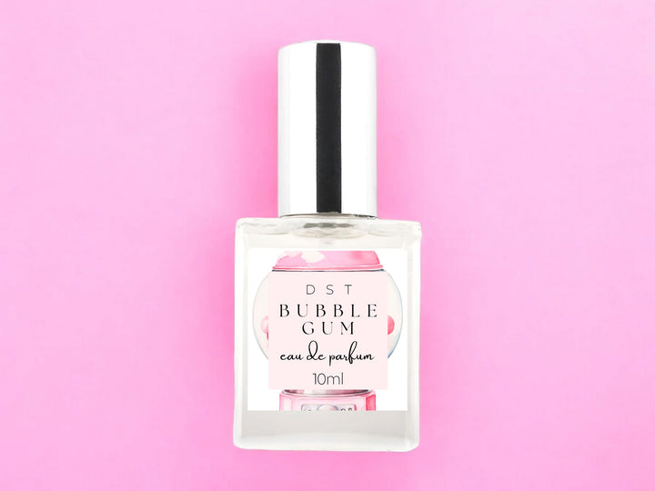 10ml bottle of Bubblegum scented Eau de Parfum spray on a pink background.