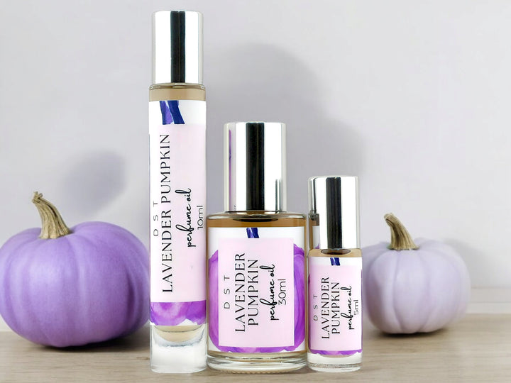 5ml, 10ml, 30ml bottles of lavender pumpkin perfume oil on white background with purple pumpkins