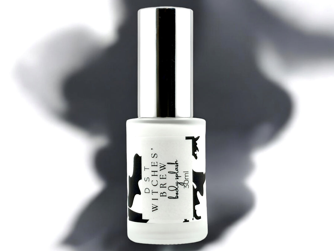 30ml bottle of Witches Brew body splash on white background with spooky black shadow.