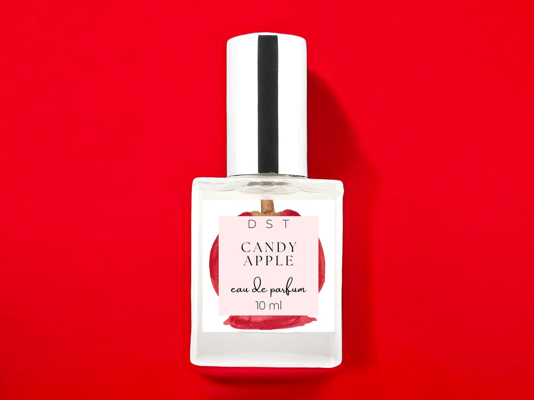 10ml bottle of Candy Apple Eau de Parfum on bright red background.