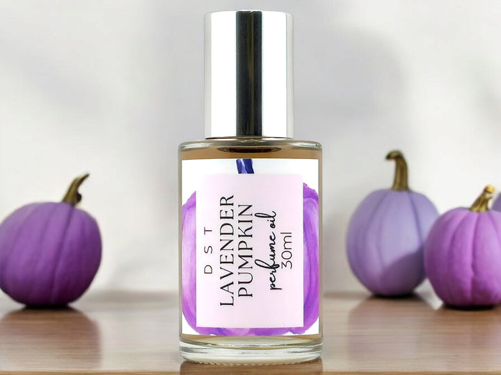 30ml bottle of lavender pumpkin perfume oil on white background with purple pumpkins