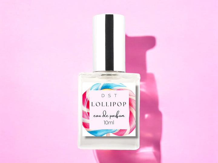 10ml bottle of Lollipop scented Eau de Parfum Spray against a pink background. 