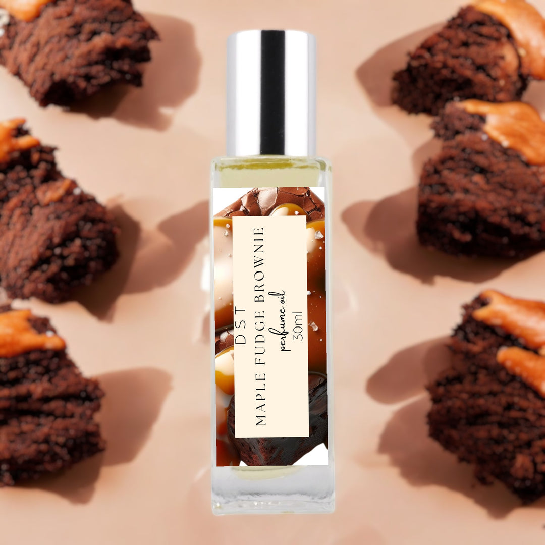 30ml bottle of Maple Fudge Brownie Perfume Oil against a tan background with chocolate brownies covered in Maple frosting.