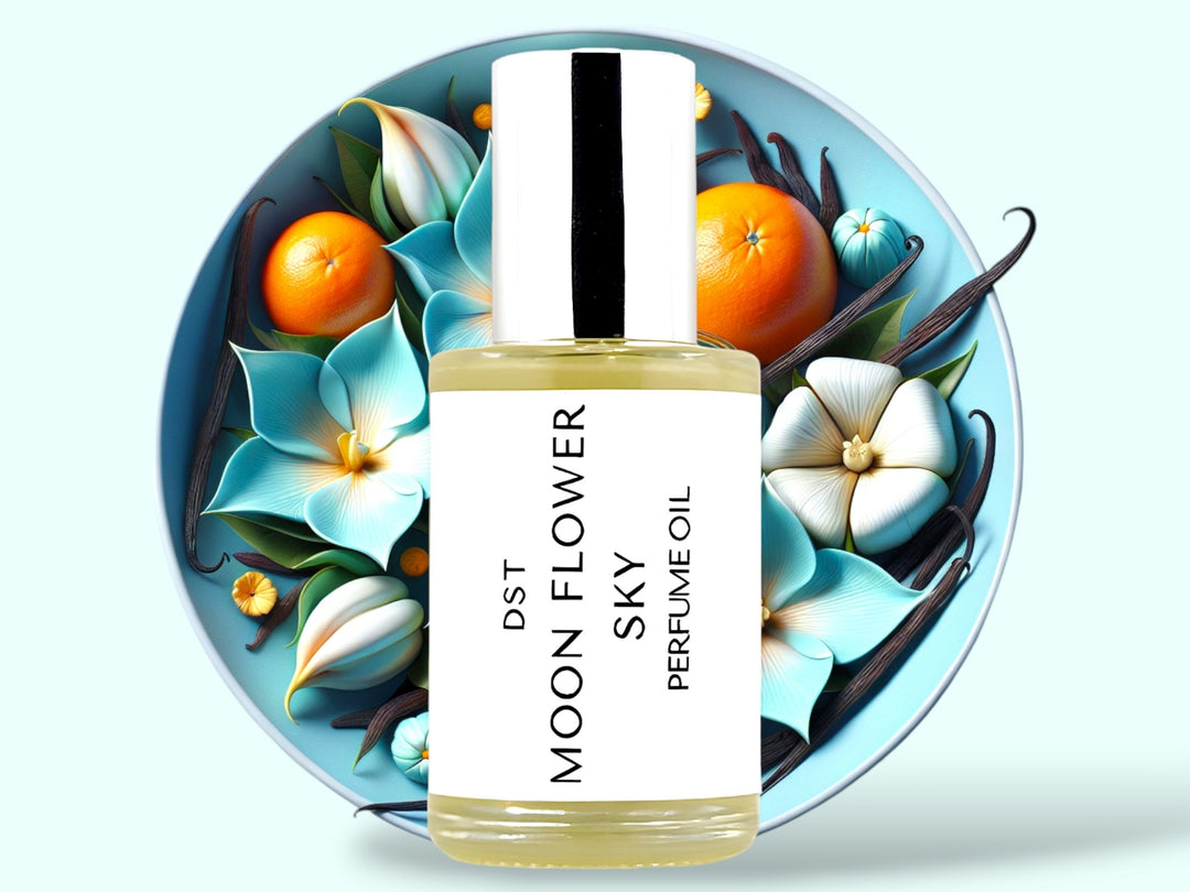 30 milliliter bottle of moonflower sky perfume oil sitting in front of a large baby blue bowl filled with moonflowers oranges and vanilla beans against a pale blue background.