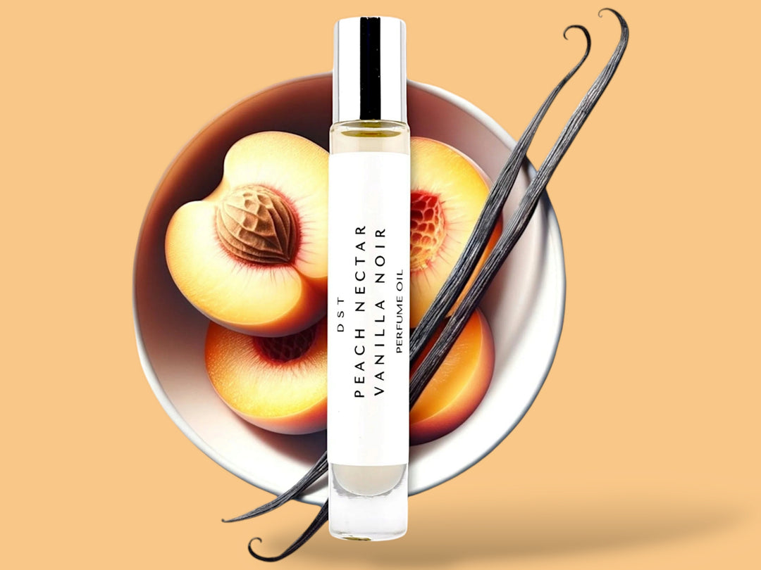 10 milliliter bottle of Peach nectar and vanilla noir perfume oil sitting in front of a large white bowl filled with Peach halves and long vanilla beans against a Peach colored background.