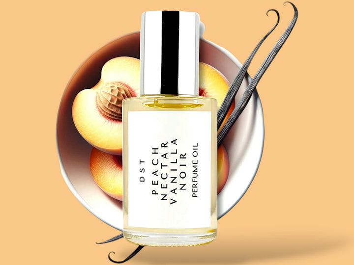 30 milliliter bottle of Peach nectar and vanilla noir perfume oil sitting in front of a large white bowl filled with Peach halves and long vanilla beans against a Peach colored background.