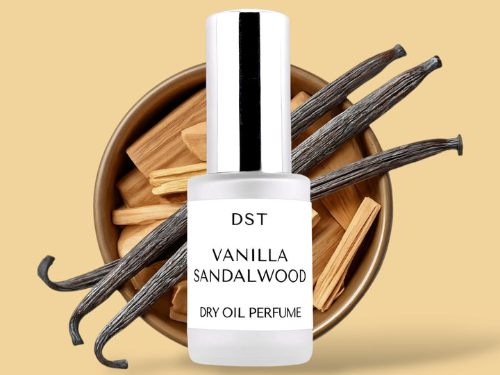 30ML bottle of Vanilla Sandalwood Dry Oil perfume spray sitting in front of a large white bowl filled with sandalwood and vanilla beans against a tan background. 