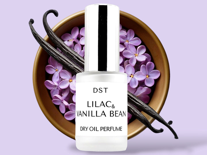 30ML bottle of Lilac and Vanilla Bean dry oil perfume sitting in front of a large wooden bowl filled with lilacs and vanilla beans against a purple background.