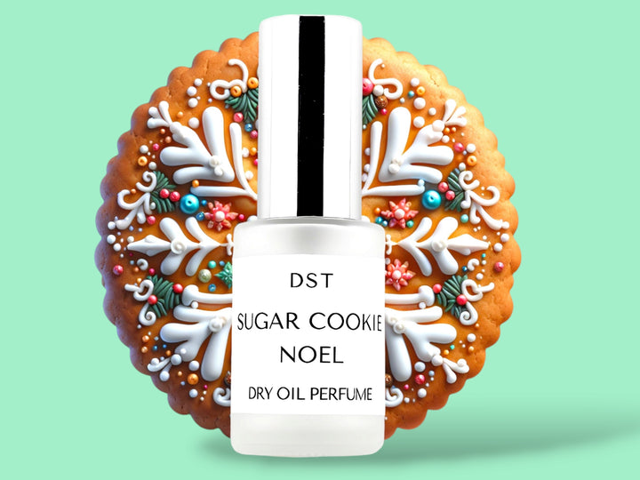 30ML bottle of Sugar Cookie Noel Dry Oil Perfume Spray sitting in front of a large fancy decorated sugar cookie against a green background. 