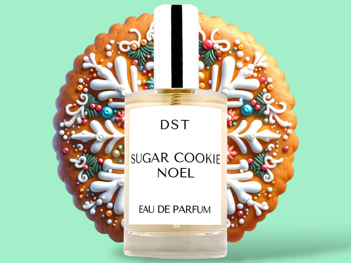 100ML bottle of Sugar Cookie Noel Parfum sitting in front of an ornately decorated sugar cookie against a pastel green background. 