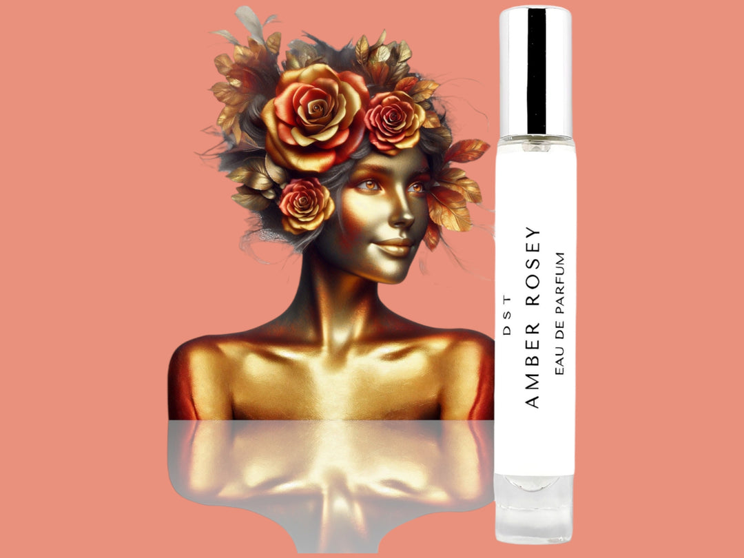 10ML bottle of Amber Rosey Parfum with the head and torso of a woman made of gold and hair made of gold leaves and amber roses, against a pink background. 