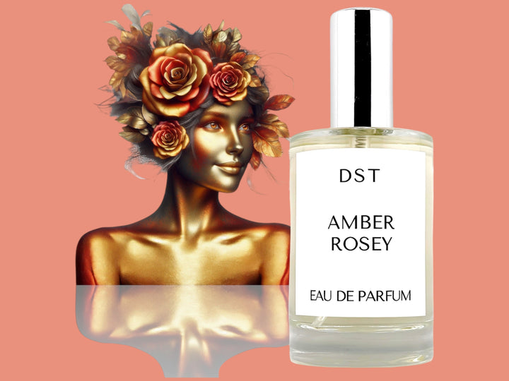 100ML bottle of Amber Rosey Parfum with the head and torso of a woman made of gold and hair made of gold leaves and amber roses, against a pink background. 