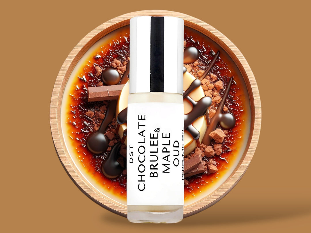 5ML bottle of Chocolate Brulee and Maple Oud perfume oil sitting in front of a large brown bowl filled with creme brulee, chocolate chunks,  and maple topping, against a light brown background. 