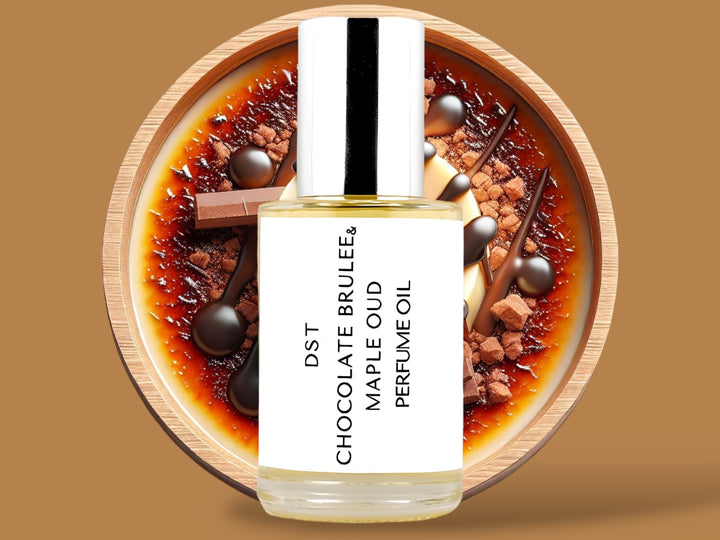 30ML bottle of Chocolate Brulee and Maple Oud perfume oil sitting in front of a large brown bowl filled with creme brulee, chocolate chunks,  and maple topping, against a light brown background. 