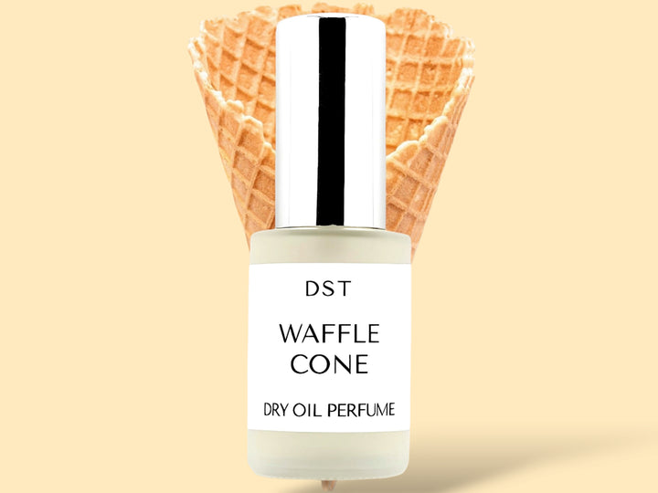 30ML bottle of Waffle Cone dry oil perfume sitting in front of a large Waffle Cone against a cream background.