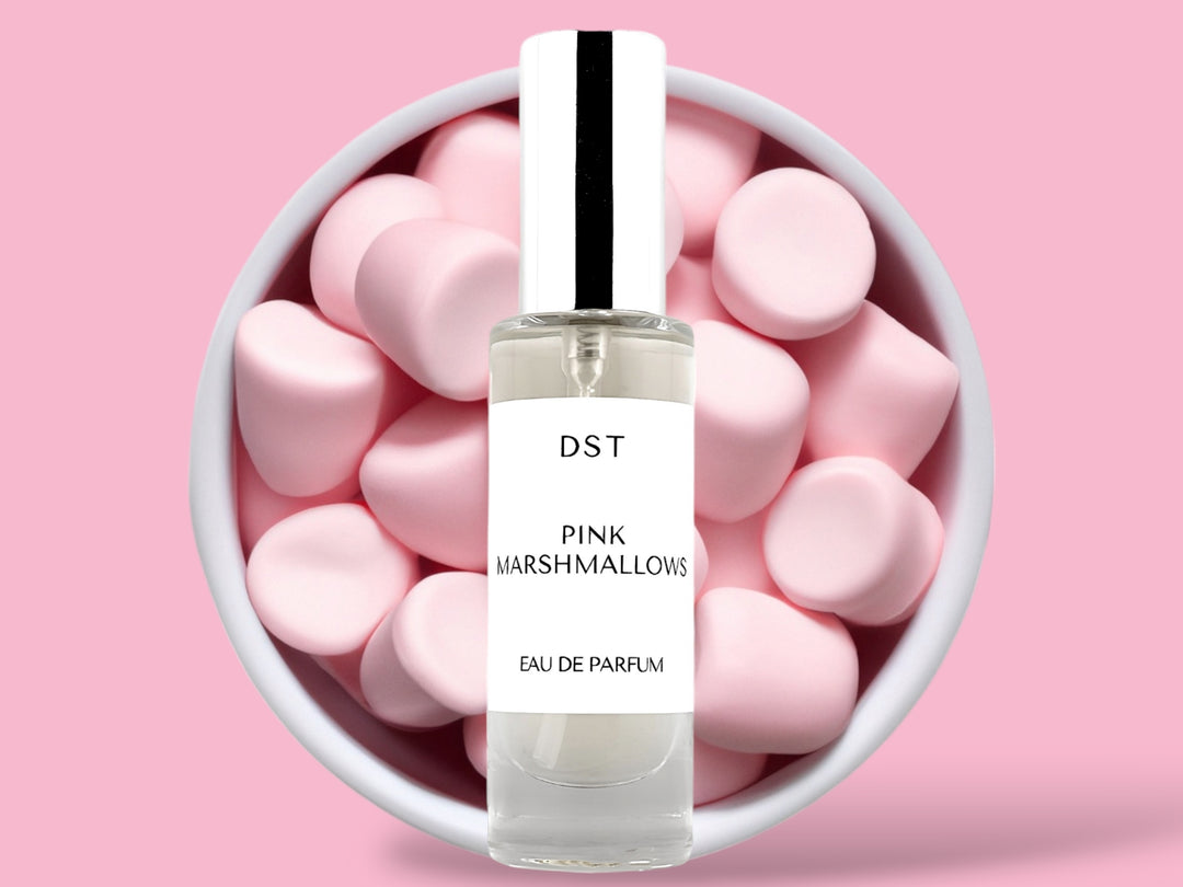 30ML bottle of Pink Marshmallows Eau de Parfum sitting in front of a large white bowl filled with fluffy pink marshmallows against a pastel pink background. 