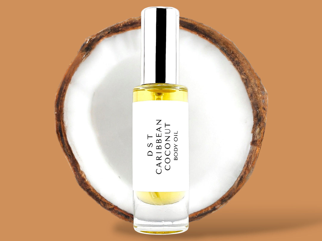 30ml bottle of Caribbean Coconut body oil sitting in front of a large opened Coconut against a brown background. 