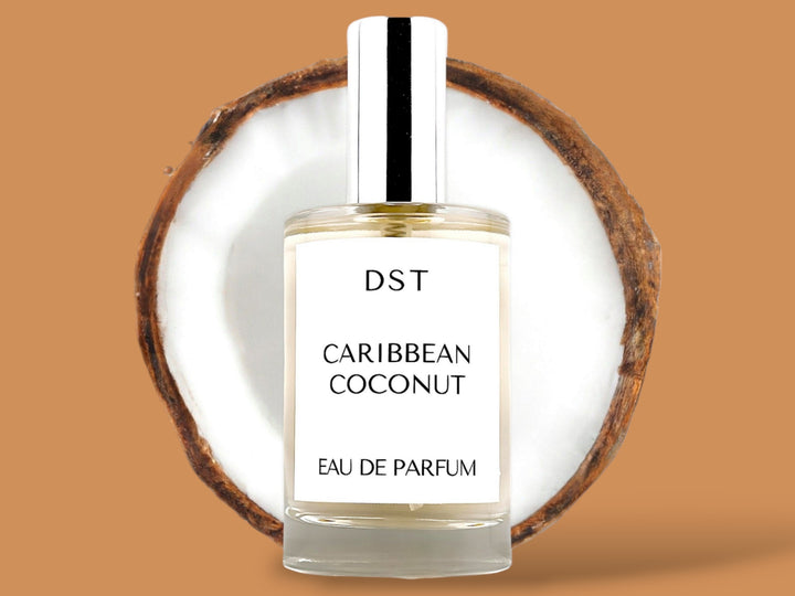 100ml bottle of Caribbean Coconut Parfum sitting in front of a large opened Coconut against a brown background. 