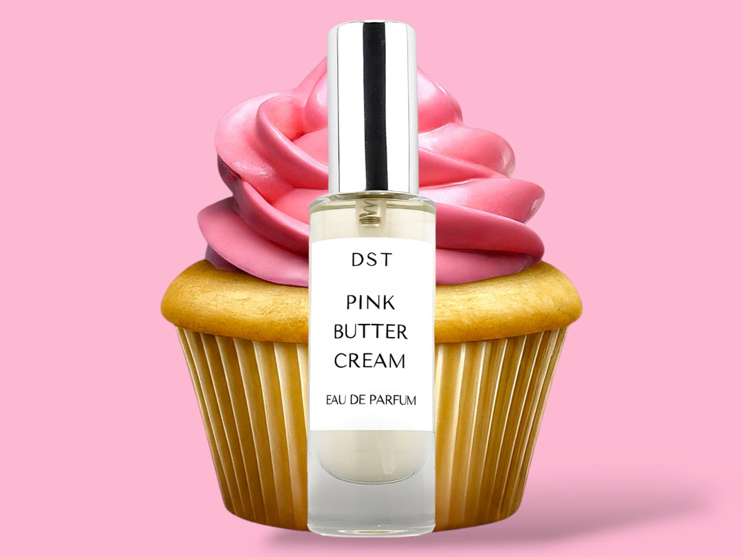 30ml bottle of Pink Butter Cream Parfum sitting in front of a large vanilla cupcake with bright pink frosting against a pink background. 