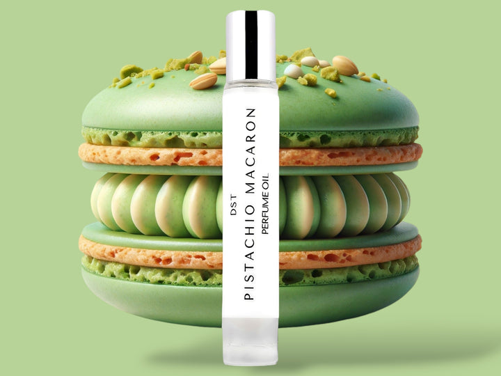 10ml bottle of Pistachio Macaron Perfume Oil sitting in front  of a large green macaron against a green background. 