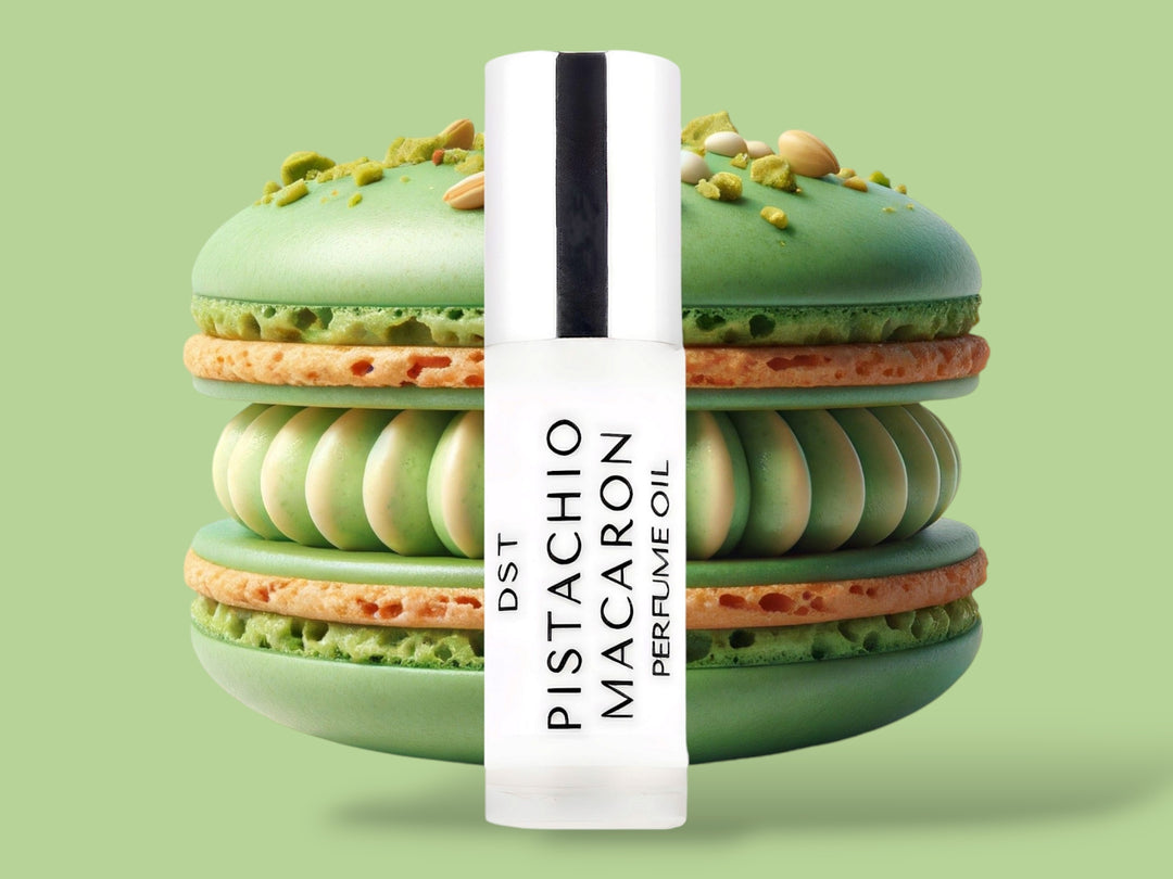 5ml bottle of Pistachio Macaron Perfume Oil sitting in front  of a large green macaron against a green background. 