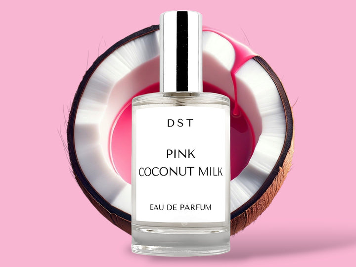 100ml bottle of Pink Coconut Milk Parfum sitting in front of a large opened Coconut that is filled with pink colored Coconut milk against a pink background. 