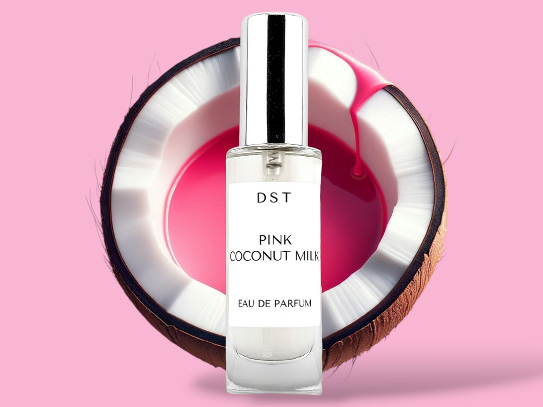 30ml bottle of Pink Coconut Milk Parfum sitting in front of a large opened Coconut that is filled with pink colored Coconut milk against a pink background. 