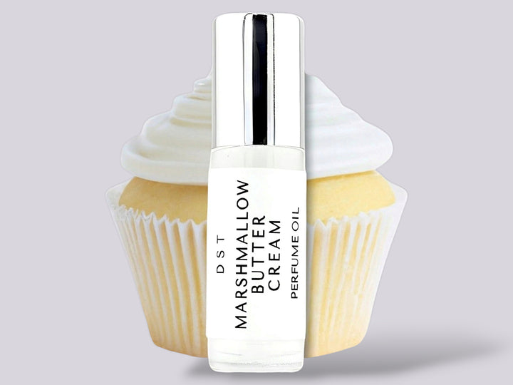 5ml bottle of Marshmallow Butter Cream Perfume Oil sitting in front  of a large vanilla cupcake against a gret background. 