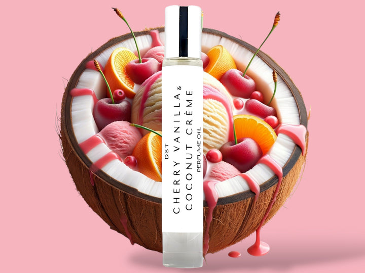 10ml bottle of Cherry Vanilla and Coconut Creme perfume oil sitting in front of a large split Coconut filled with Cherries, orange slices, and cherry syrup drizzle against a pink background.