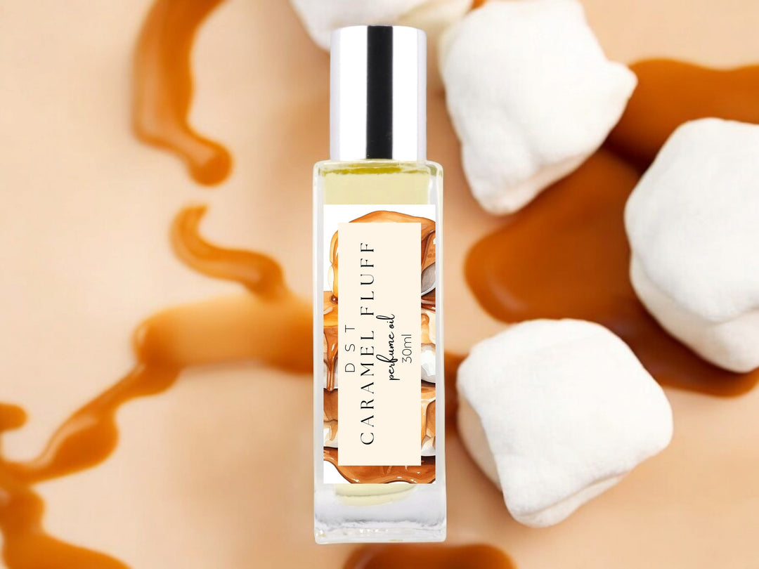 30ml bottle of caramel fluff perfume oil on tan background with white marshmallows covered in caramel