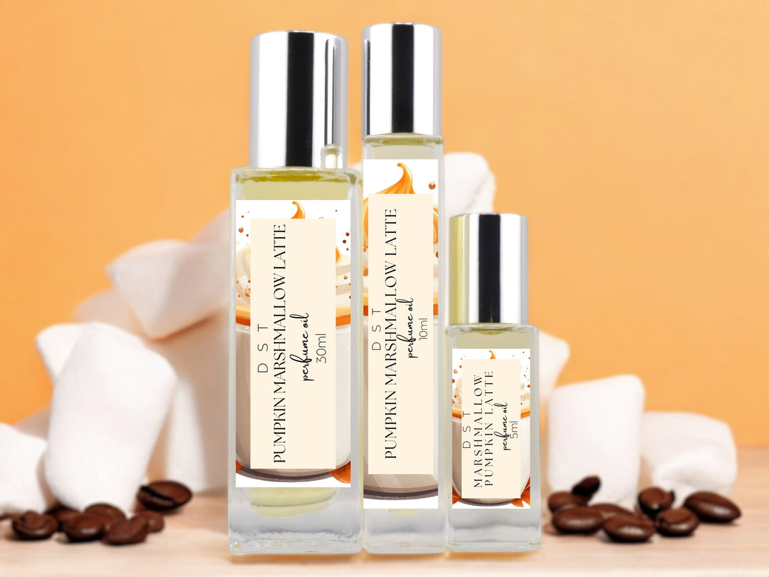 5ml, 10ml, 30ml bottles of marshmallow pumpkin latte perfume oil in on orange background with white marshmallows and coffee beans