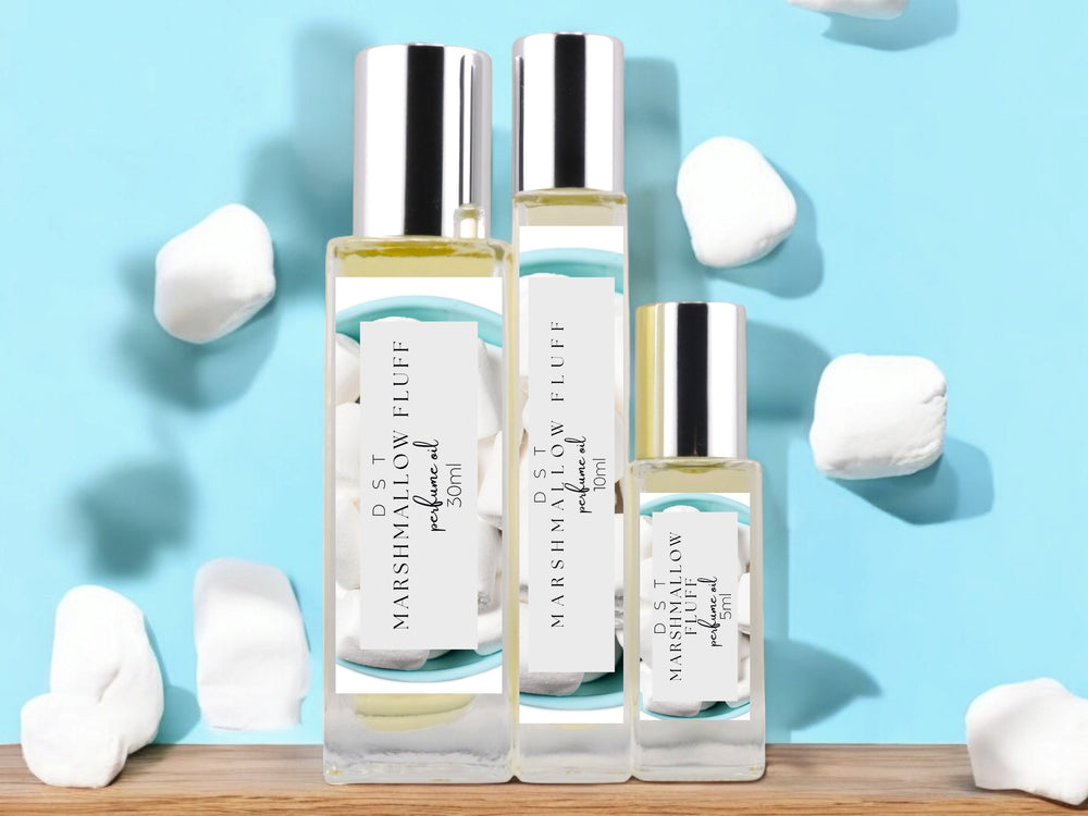 5, 10ml, and 30ml bottles of Marshmallow Fluff scented Perfume Oil surrounded by light blue background and puffy white marshmallows. 