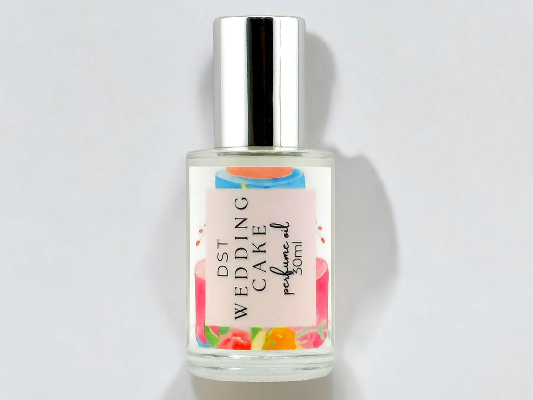 30ml bottle of Wedding Cake perfume oil against a shadowy white background. 