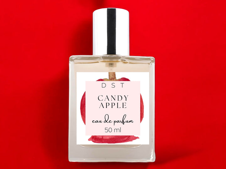 50ml bottle of Candy Apple Eau de Parfum on bright red background.