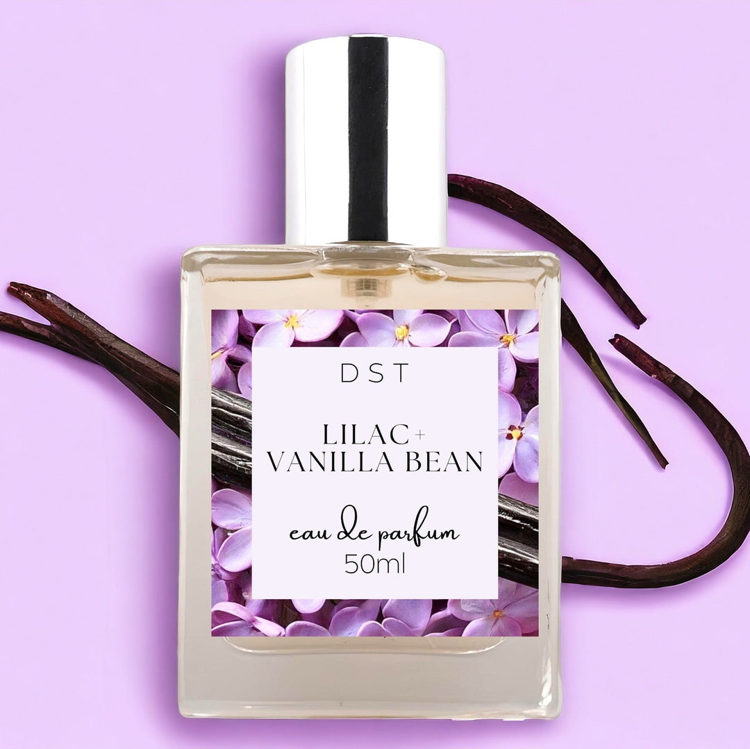 50ml bottle of Lilac and Vanilla Bean perfume against a light purple surface with Vanilla Bean. 