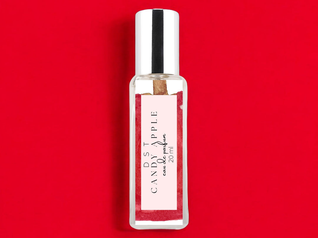 20ml bottle of Candy Apple Eau de Parfum on bright red background.