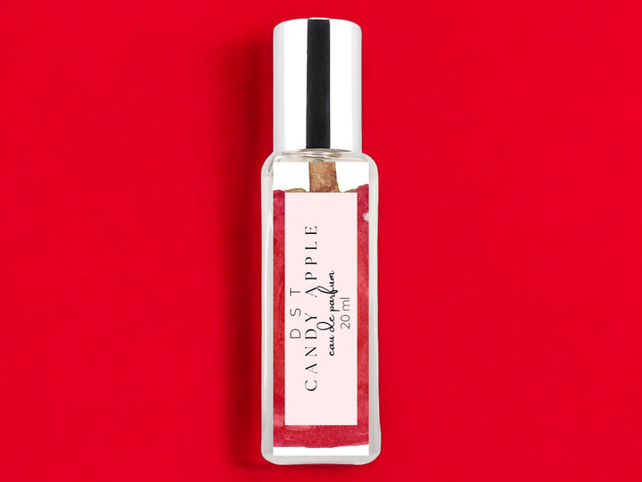 20ml bottle of Candy Apple Eau de Parfum on bright red background.