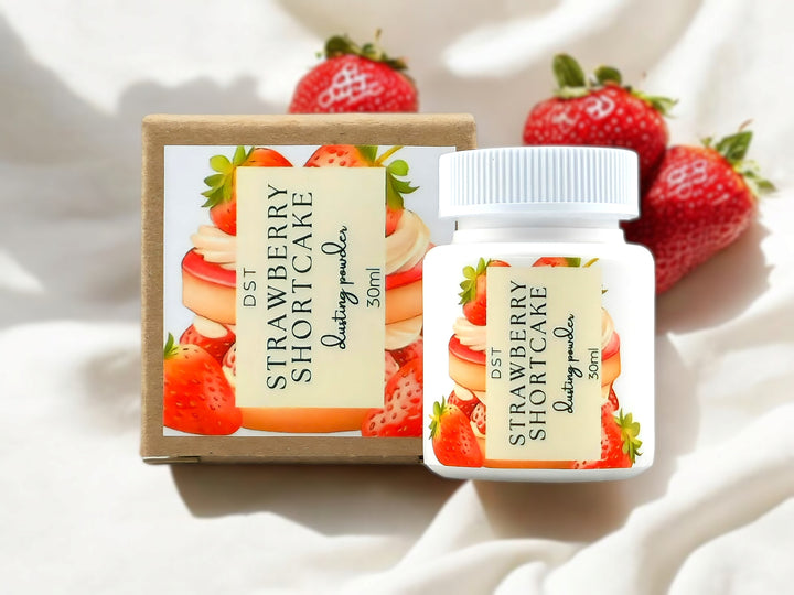 A 30ml bottle of strawberry shortcake scented body powder and the box it is packaged in.