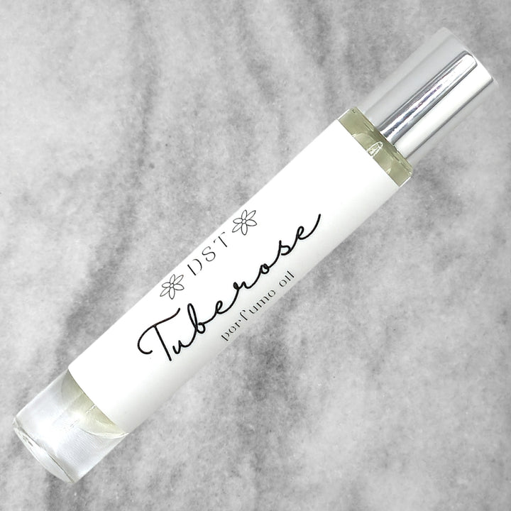 10ml bottle of Tuberose perfume oil against a grey background. 