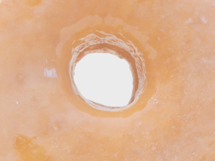 Muted video showing text fragrance description for Glazed Donut.  Warm vanilla glaze mingles with baked pastry dough, leaving a  mouthwatering aroma that captures the essence of a warm glazed donut.  
