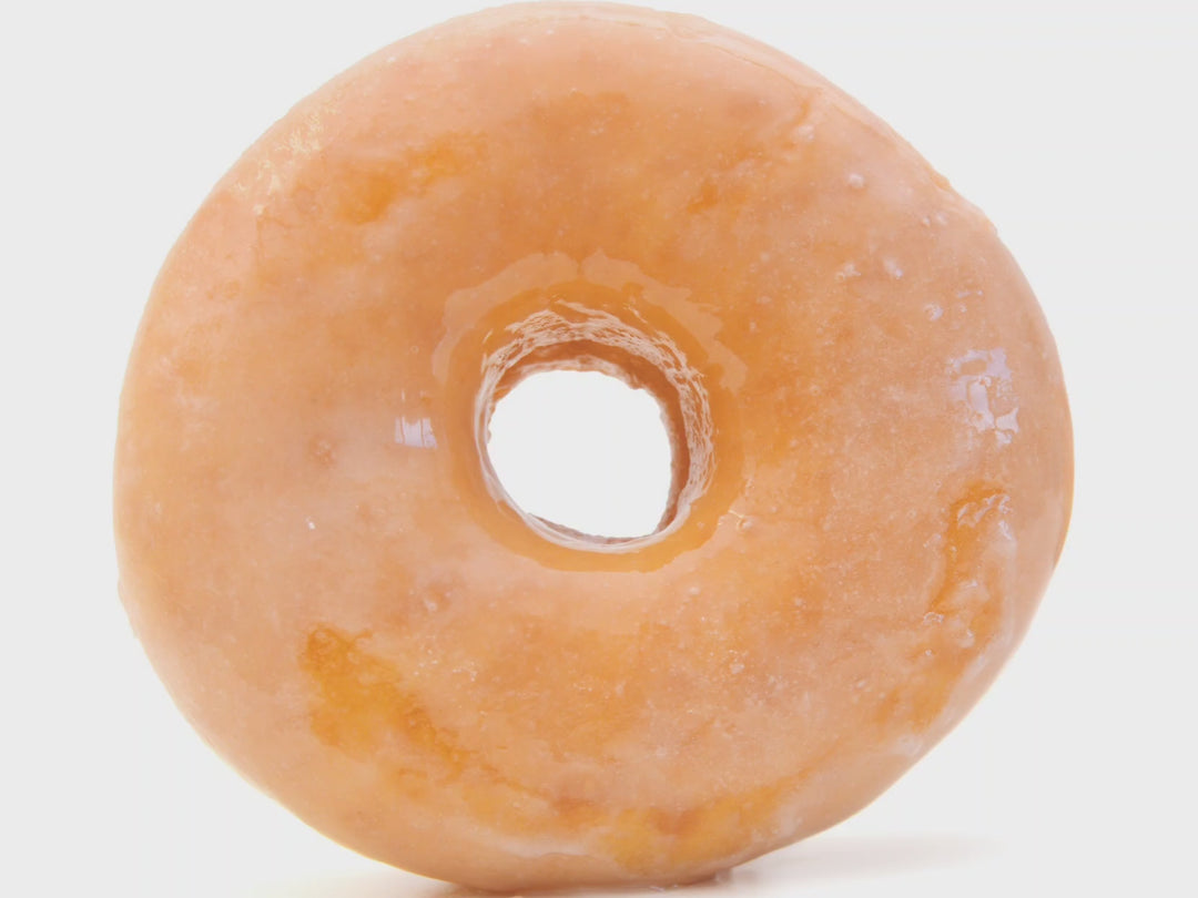 muted video of text fragrance description for Glazed Donut: Warm vanilla glaze mingles with baked pastry dough leaving a mouthwatering aroma that captures the essence of a warm glazed donut.