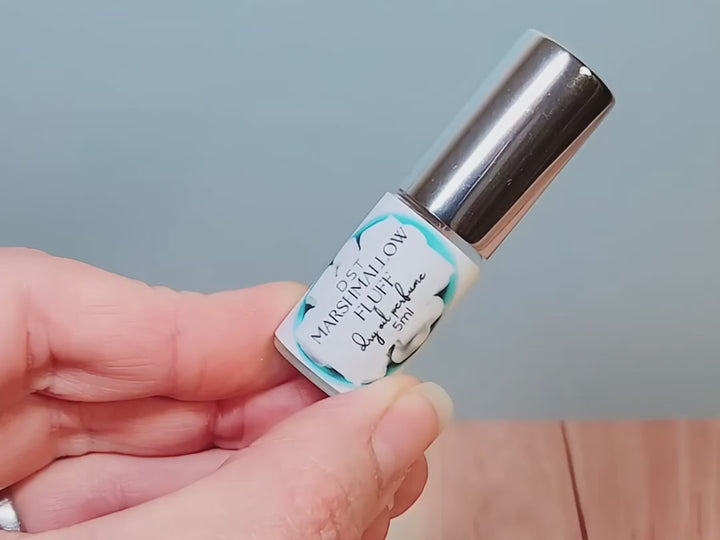 5ml bottle of Marshmallow Fluff Dry Oil Perfume Spray against a pastel blue background.